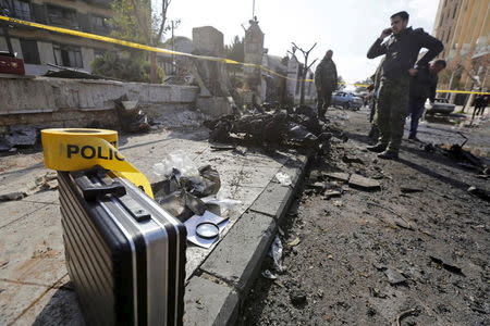 Syrian army soldiers inspect the site of a suicide bombing at a police officers' club in a residential district of Damascus, in Masaken Barza, Syria February 9, 2016. REUTERS/Omar Sanadiki