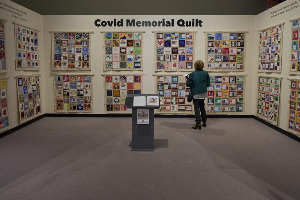 Susan Dale, immediate past president of Historical League, looks at the Covid Memorial Quilt exhibit at the Arizona Historical Society Museum in Tempe on March 7, 2022.