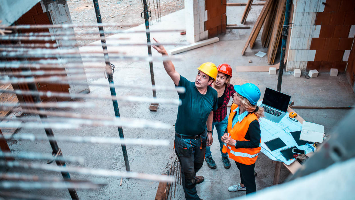 Group of architects planning on construction site.