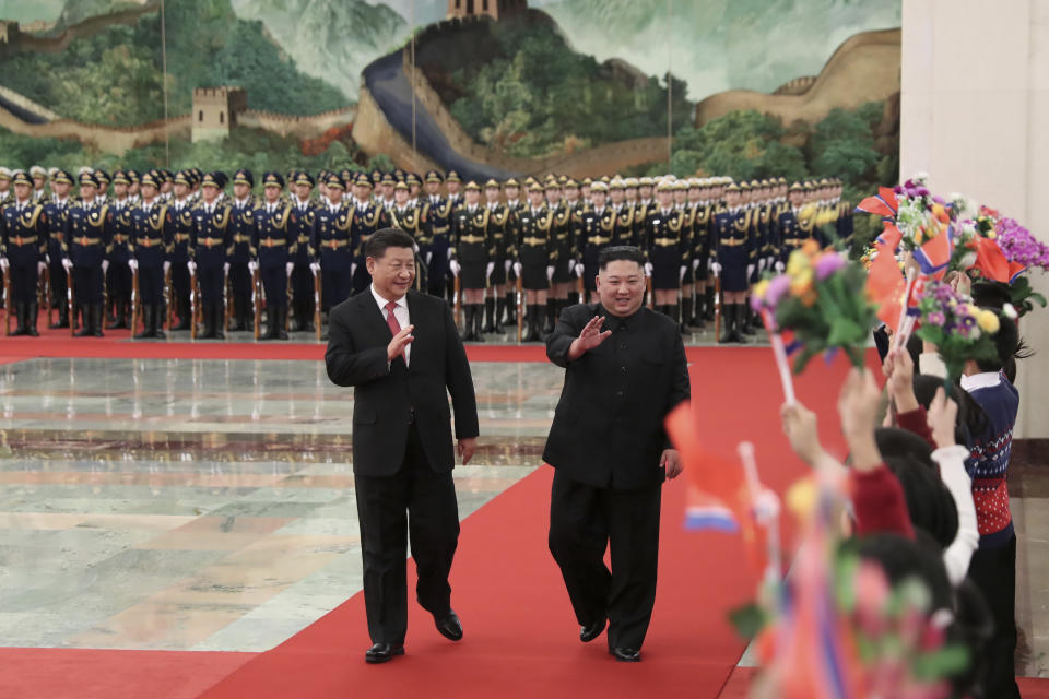 FILE - In this Jan. 8, 2019, file photo released by China's Xinhua News Agency, North Korean leader Kim Jong Un, right, is cheered by children during a welcome ceremony held by Chinese President Xi Jinping, left, at the Great Hall of the People in Beijing. Xi said North Korea is taking the "right direction" by politically resolving issues on the Korean Peninsula in a rare op-ed published by a North Korean state newspaper Wednesday, June 19, 2019, a day before Xi visits Pyongyang to meet Kim. (Huang Jingwen/Xinhua via AP, File)