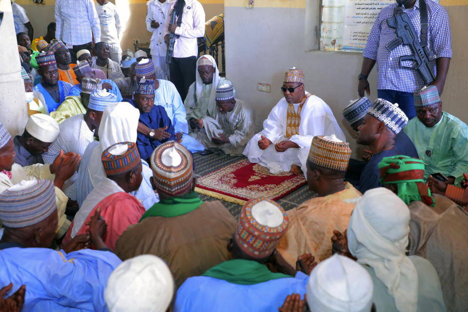 Babagana Umara Zulum, center, governor of Borno State, prays during a funeral for those killed by suspected Boko Haram militants in Zaabarmar, Nigeria, Sunday, Nov. 29, 2020. Nigerian officials say suspected members of the Islamic militant group Boko Haram have killed at least 40 rice farmers and fishermen while they were harvesting crops in northern Borno State. The attack was staged Saturday in a rice field in Garin Kwashebe, a Borno community known for rice farming. (AP Photo/Jossy Ola)