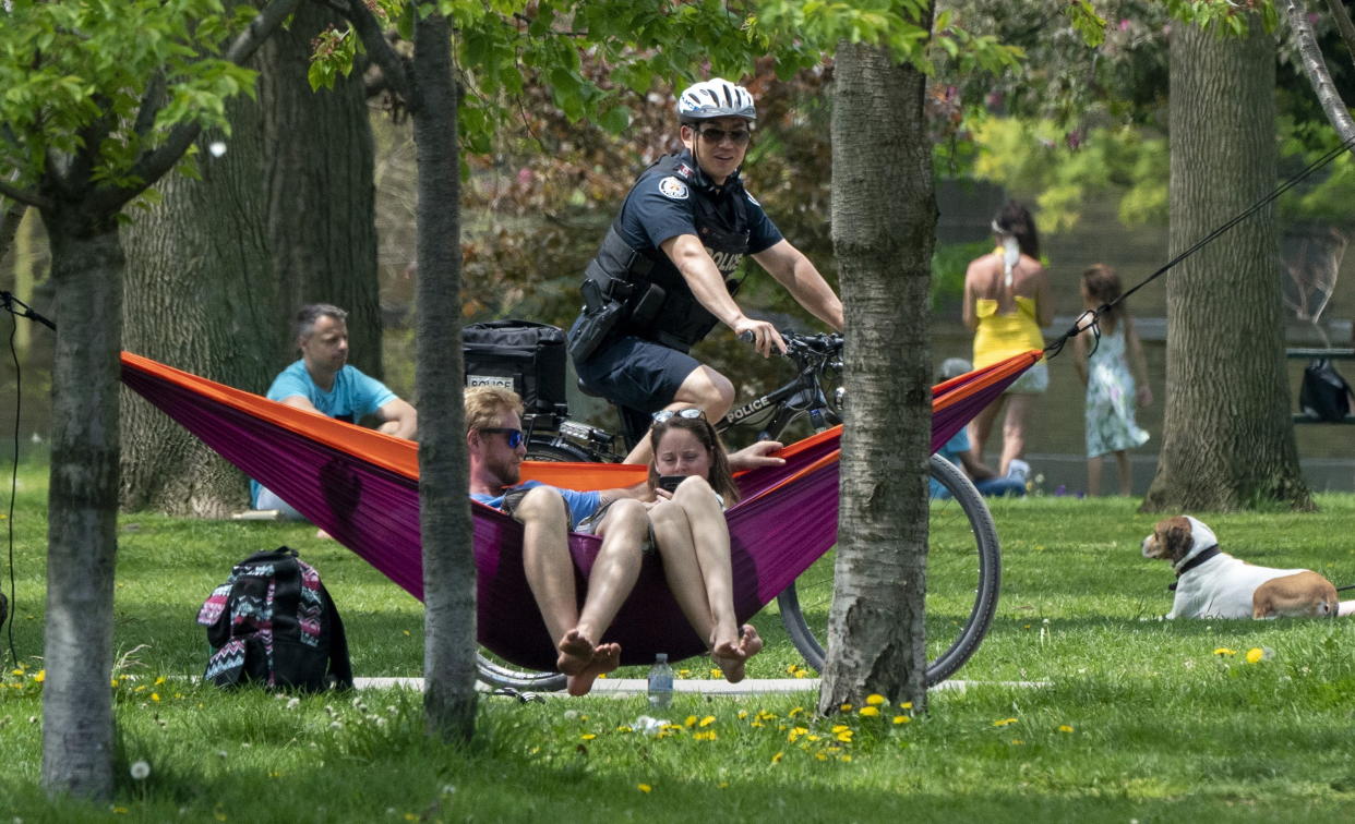 A bicycle police officer patrols Trinity Bellwoods Park in Toronto on Sunday, May 24, 2020. Warm weather and a reduction in COVID-19 restrictions has many looking to the outdoors for relief. THE CANADIAN PRESS/Frank Gunn