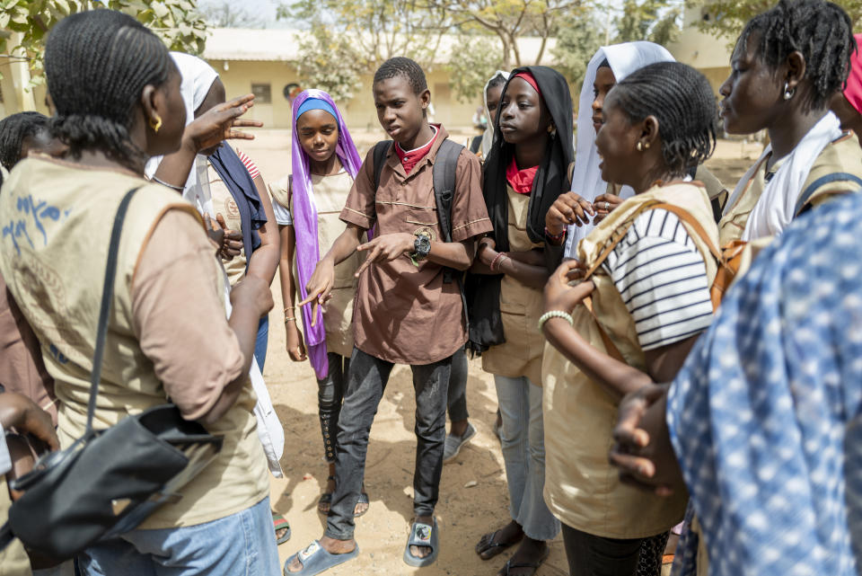 Mouhamed Sall, who is deaf, communicates using sign language at the Guinaw Rail Sud public high school in Pikine, Senegal, Monday, March 18, 2024. Sall and three other students are part of a new approach in a small number of schools in Senegal that seat those who are deaf and hard of hearing with the rest of the class. (AP Photo/Sylvain Cherkaoui)