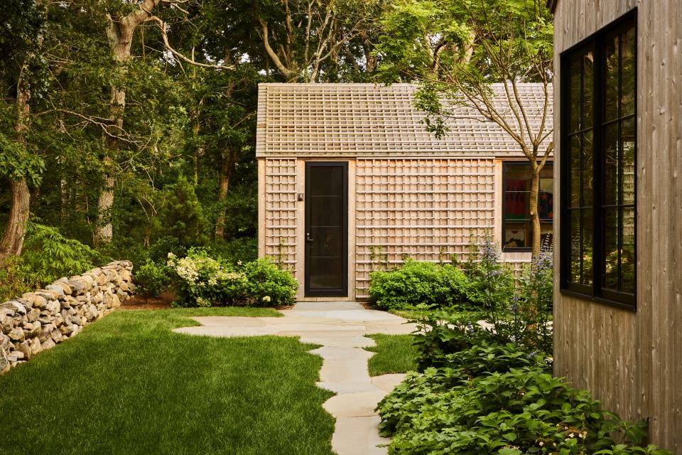 The guest house, which looks onto the pool, is built with a trellis armature on one face of the building, where hydrangea vines are expected to grow over the coming years. Bluestone creates meandering paths throughout the property.