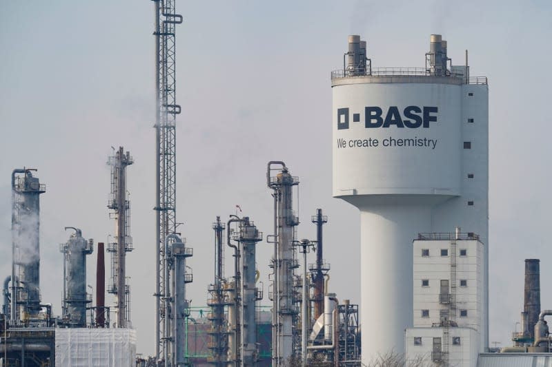 A tower with the inscription "BASF" stands next to chimneys on the site of the chemical company BASF. German chemical and battery giant BASF saw a return to profit in fiscal year 2023, with a net income of €225 million ($244 million), compared to a loss of €627 million in 2022. Uwe Anspach/dpa