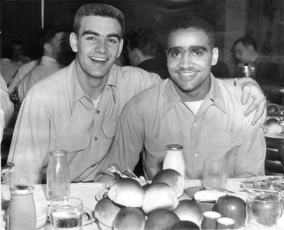Johnny Bright (right) and Bob Binette (left) were elected co-captains of the 1951 Drake football team at a dinner. Bright was the first Black player to be captain at Drake.