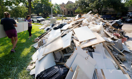 Church Volunteers work to remove Hurricane Harvey flood damage from a home in Houston, Texas, U.S. September 2, 2017. REUTERS/Rick Wilking