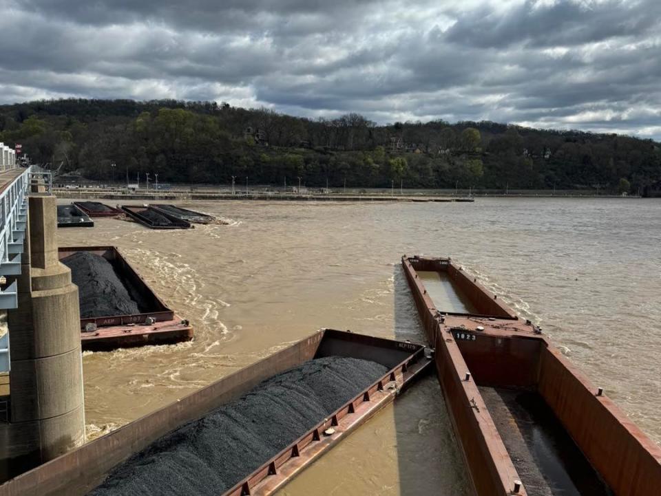 One of the coal-filled barges attempts to slide through the piers.