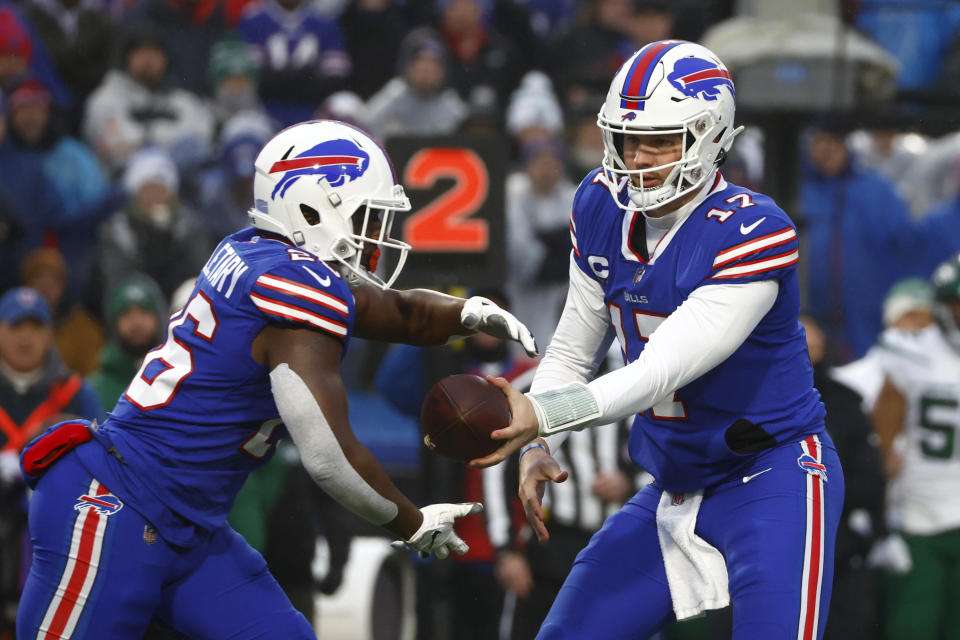 Buffalo Bills quarterback Josh Allen (17) hands off to running back Devin Singletary (26) during the first half of an NFL football game against the New York Jets, Sunday, Dec. 11, 2022, in Orchard Park, N.Y. (AP Photo/Jeffrey T. Barnes)
