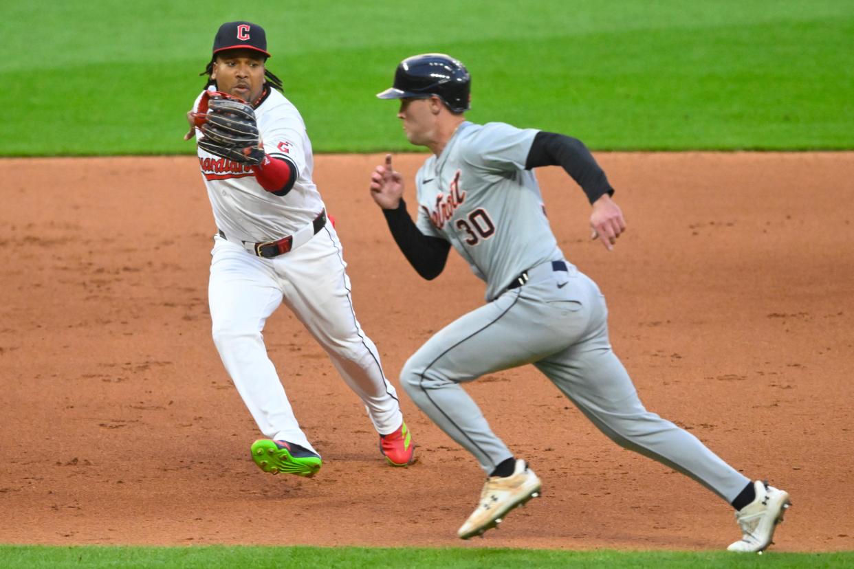Detroit Tigers right fielder Kerry Carpenter (30) runs by the tag attempt of Cleveland Guardians third baseman Jose Ramirez (11) in the eighth inning Monday at Progressive Field.