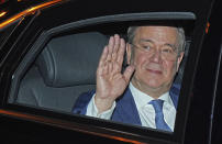 Armin Laschet, Federal Chairman of the CDU, top candidate of his party for Chancellor waves as he returns to Konrad Adenauer House after a TV appearance in Berlin, Sunday, Sept. 26, 2021. Exit polls show the center-left Social Democrats in a very close race with outgoing Chancellor Angela Merkel's bloc in Germany's parliamentary election, which will determine who succeeds the longtime leader after 16 years in power. (Michael Kappeler/DPA via AP)