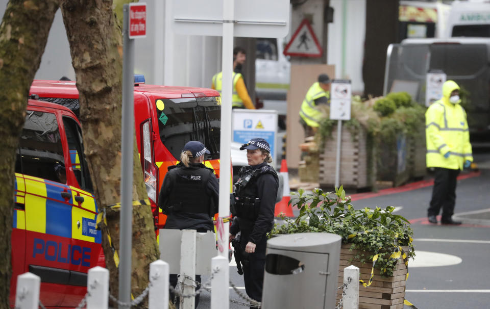 Police officers stand guard outside a hospital where it is believed that Britain's Prime Minister Boris Johnson is undergoing tests after suffering from coronavirus symptoms, in London, Monday, April 6, 2020. British Prime Minister Boris Johnson has been admitted to a hospital with the coronavirus. Johnson's office says he is being admitted for tests because he still has symptoms 10 days after testing positive for the virus. (AP Photo/Frank Augstein)