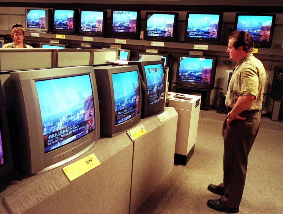 At the Sears on Coral Way in Miami, Juan Hernandez watches live coverge of 9/11 in the electronics department.