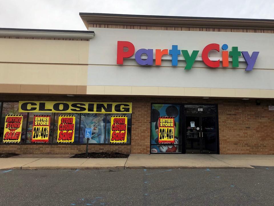 Party City store with closing signs pasted on windows