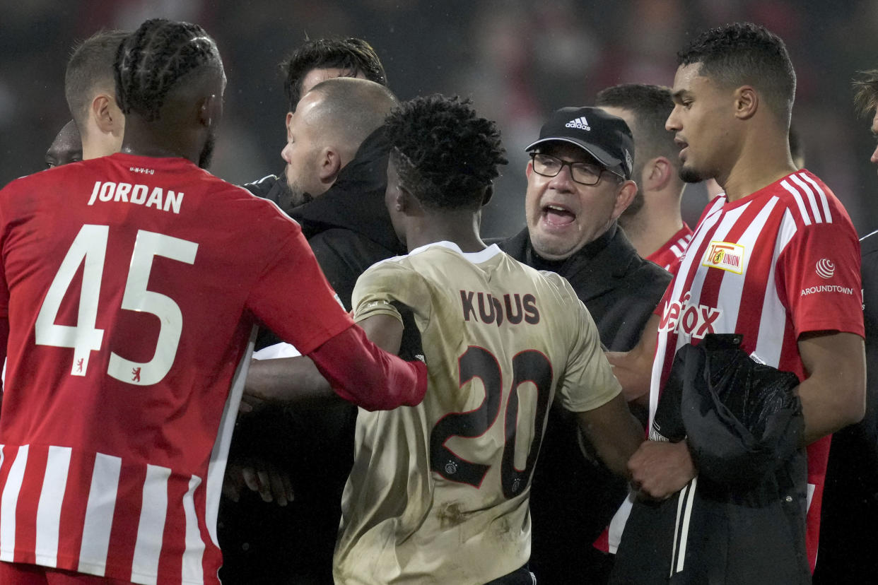 Union head coach Urs Fischer, second right, tries to calm down players and team staff after the Europa League match against Ajax on Thursday in Berlin. Union Berlin defeated Ajax 3-1. (AP Photo/Michael Sohn)