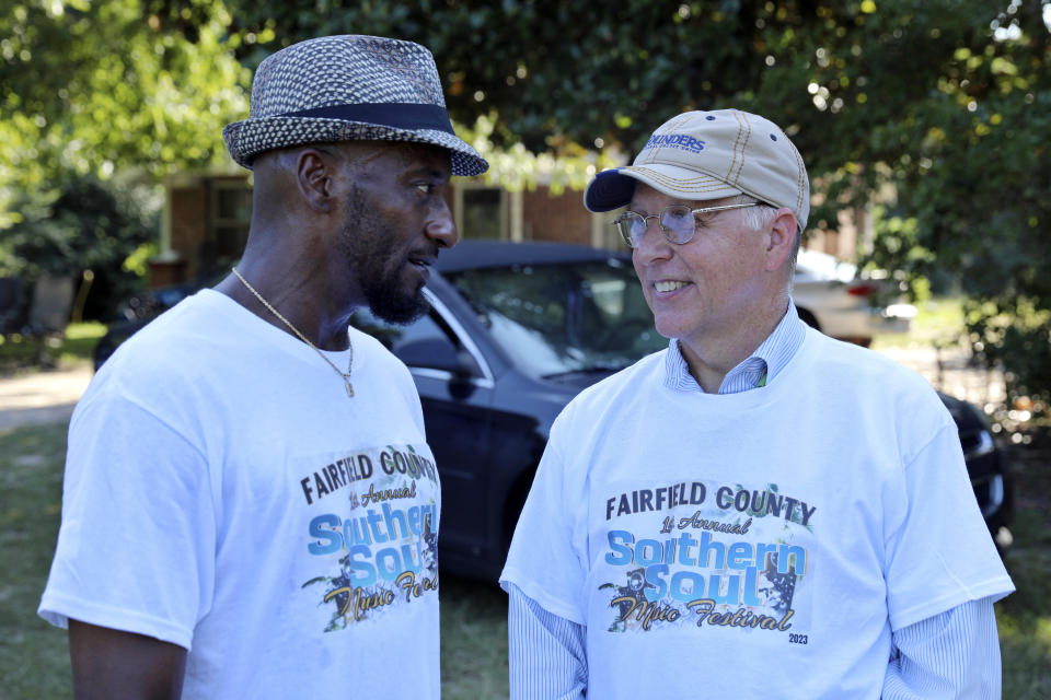 South Carolina state Sen. Mike Fanning, D-Great Falls, right, talks to a constituent as he travels across his district, Saturday, Aug. 5, 2023, in Winnsboro, S.C. In an increasingly Republican state, Fanning hopes the personal touch can help him keep his seat. (AP Photo/Jeffrey Collins)