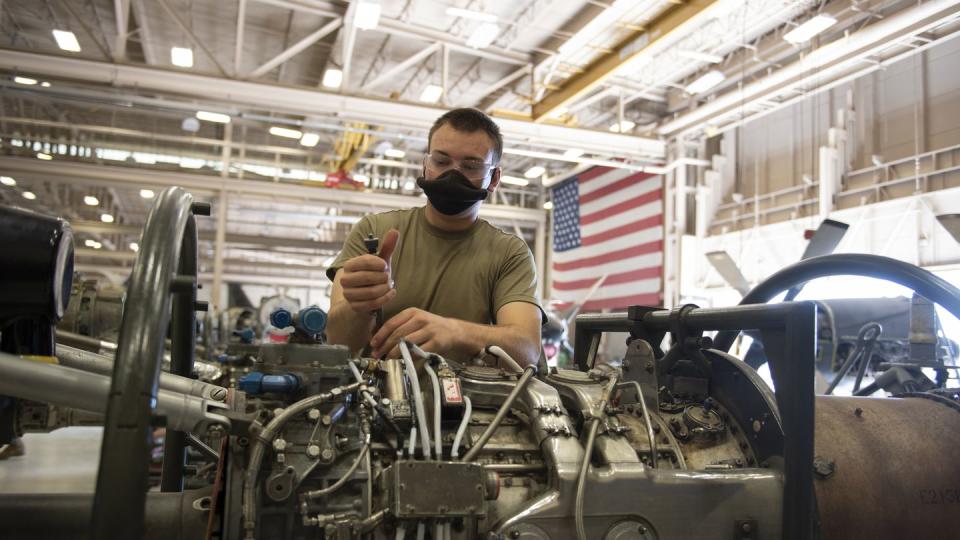 Airman Tyler Mckenna, a 361st Training Squadron propulsion apprentice course student, safety wires an electric plug on an aircraft engine at Sheppard Air Force Base, Texas, in June ]2020. (Alan R. Quevy/Air Force)