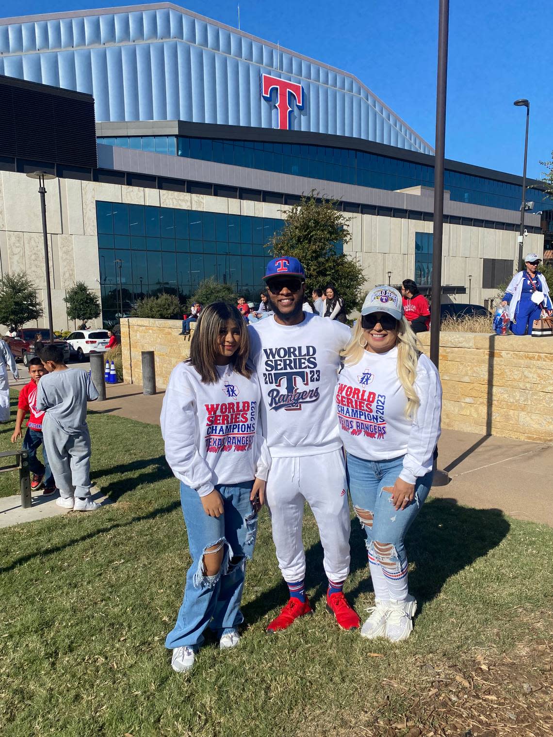 From left to right, Mya, Jay and Vanessa White display sweatshirts they made at home to celebrate the Rangers World Series win. Jenny Rudolph