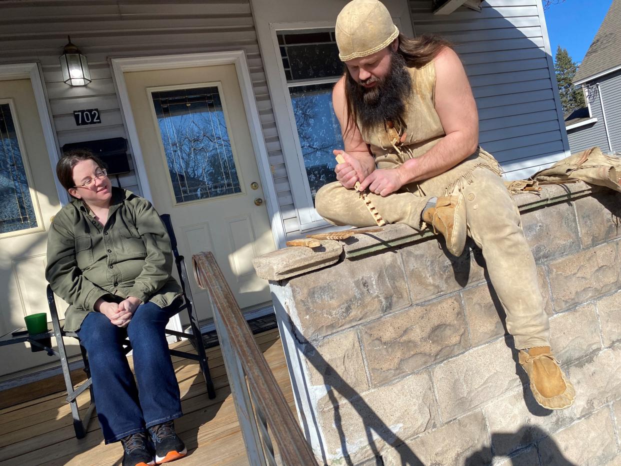 Mammoth Hunter Sean Sullivan works on a fire-starting kit while chatting with his wife, Carol Poppe.