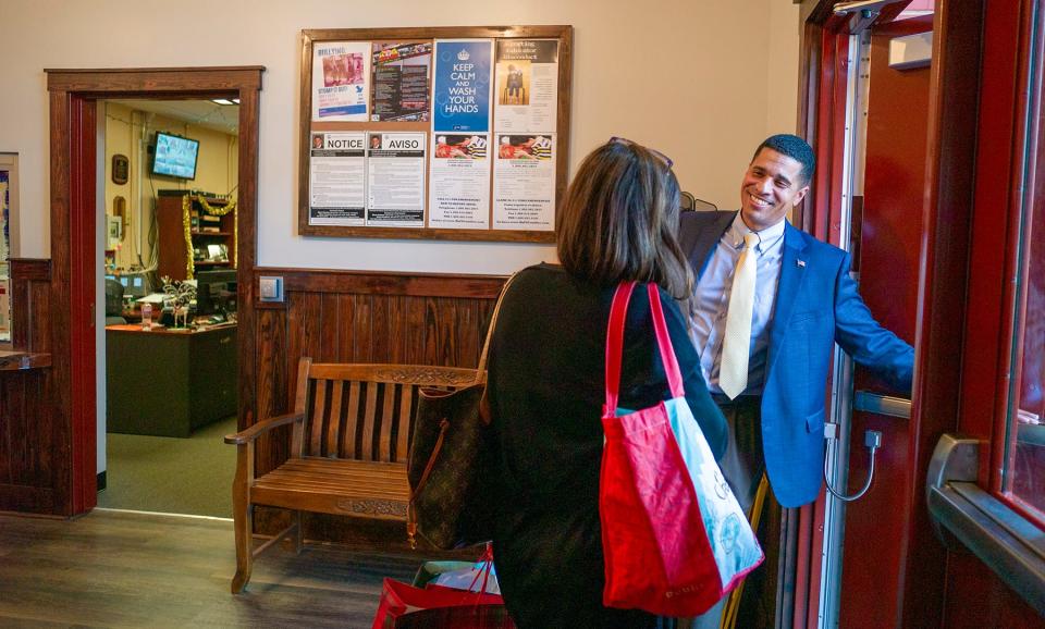 Okaloosa County School District Superintendent Marcus Chambers holds the front door for a departing teacher at Edge Elementary School in Niceville.  About 10% of the district's 1,904 teachers missed school last Wednesday, Thursday and Friday.