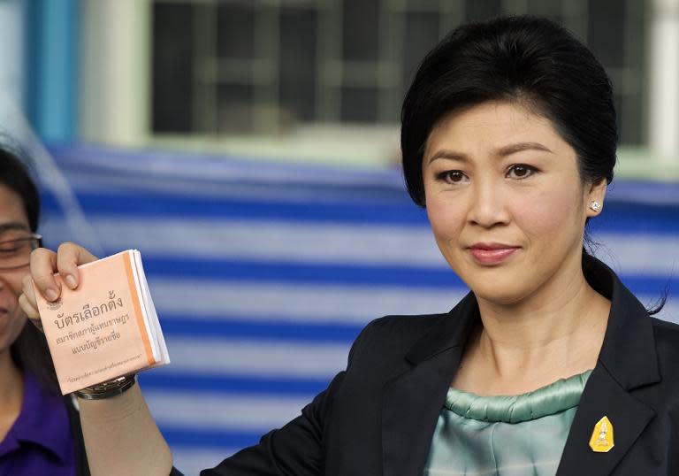 Thai Prime Minister Yingluck Shinawatra shows her vote at a polling station in Bangkok, on February 2, 2014