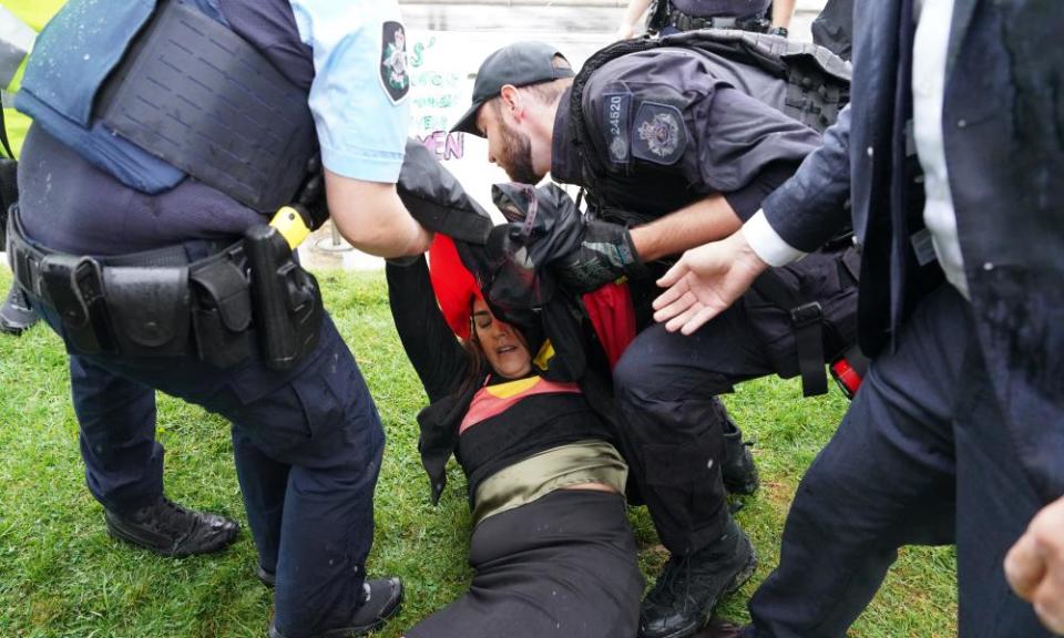 Lidia Thorpe on the ground with several police standing over her