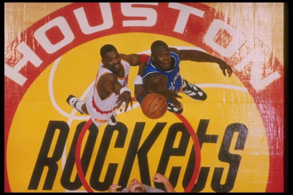 Center Hakeem Olajuwon of the Houston Rockets and Orlando Magic center Shaquille O'Neal go up for the ball during a Finals game at The Summit in Houston, Texas on June 14, 1995. (AllSport)