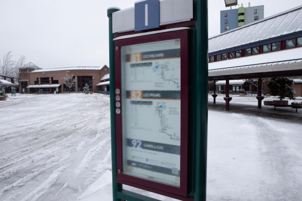 A frozen layer of ice obscures the bus routes on a sign at a deserted Eugene Station bus station Monday morning Jan. 15, 2024. Bus travel was suspended after an ice storm made roads dangerous.