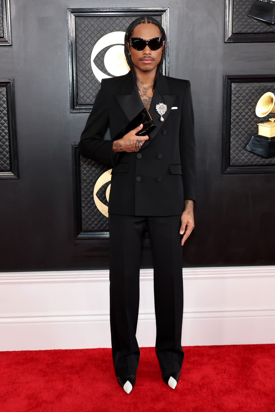 <p>Earlier this week, <em><a href="https://www.rollingstone.com/music/music-lists/most-stylish-musicians-2023-1234665705/steve-lacy-1234665707/" rel="nofollow noopener" target="_blank" data-ylk="slk:Rolling Stone;elm:context_link;itc:0;sec:content-canvas" class="link ">Rolling Stone</a></em> named Steve Lacy the most stylish musician of 2023, and he defended his title tonight in head-to-toe Saint Laurent. Lacy wore a double cross tuxedo pinned with a rhinestone and pearl shield brooch, knife-sharp boots, and oversized bug-like sunglasses while holding the brand's glossy Manhattan clutch against his chest like a priest holds a bible.</p>