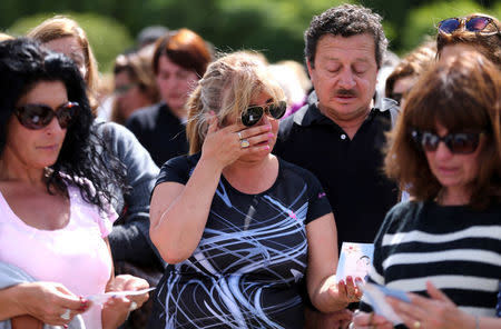 A woman reacts as people gather to pray for the 44 crew members of the missing at sea ARA San Juan submarine, at the entrance of an Argentine Naval Base in Mar del Plata, Argentina November 22, 2017. REUTERS/Marcos Brindicci