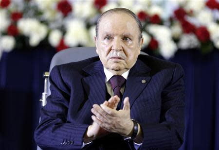President Abdelaziz Bouteflika claps during a swearing-in ceremony in Algiers April 28, 2014. REUTERS/Louafi Larbi