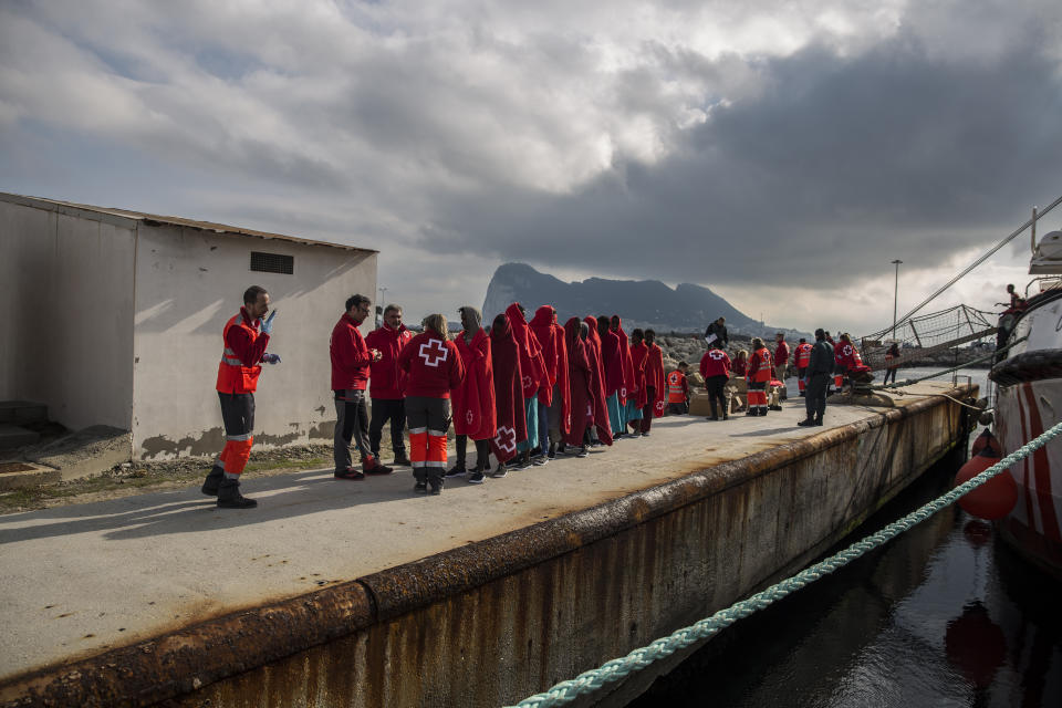 Migrants disembark from the Spanish NGO Proactiva Open Arms rescue vessel, after being rescued Dec. 21, in the Central Mediterranean Sea, before disembarking in the port of Crinavis in Algeciras, Spain, Friday, Dec. 28, 2018. The Proactiva Open Arms aid boat carrying over 300 migrants rescued at sea, has ended a weeklong journey across the western Mediterranean Sea to dock at the Spanish port of Algeciras on Friday. (AP Photo/Olmo Calvo)