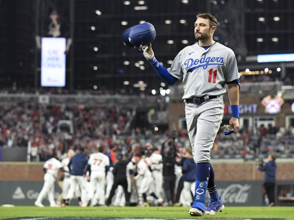 Los Angeles Dodgers' AJ Pollock tosses his helmet after grounding out