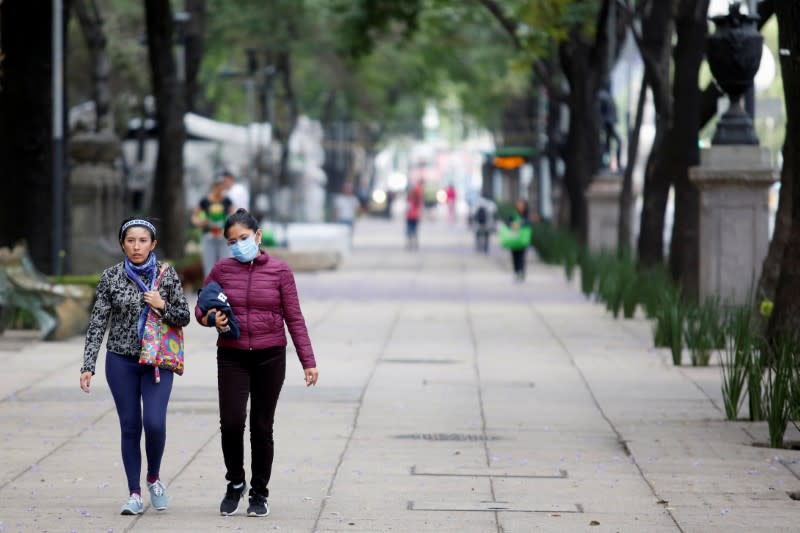 Women walk on a street as the coronavirus disease (COVID-19) outbreak continues, in Mexico City
