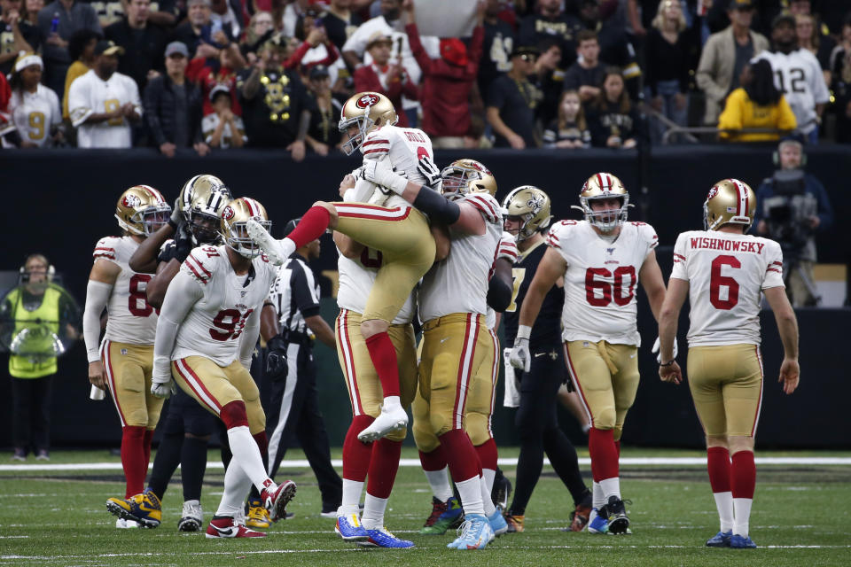 San Francisco 49ers kicker Robbie Gould (9) celebrates his game winning field goal with his team at the end of regulation in the second half an NFL football game against the New Orleans Saints in New Orleans, Sunday, Dec. 8, 2019. The 49ers won 48-46. (AP Photo/Butch Dill)