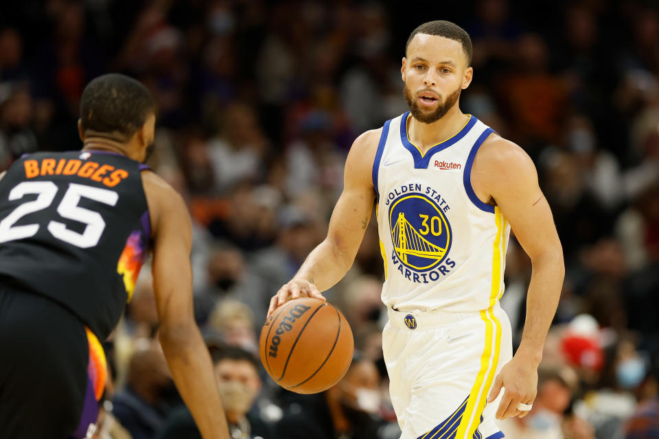 PHOENIX, ARIZONA - DECEMBER 25:  Stephen Curry #30 of the Golden State Warriors handles the ball during the first half of NBA game at Footprint Center on December 25, 2021 in Phoenix, Arizona.  NOTE TO USER: User expressly acknowledges and agrees that, by downloading and or using this photograph, User is consenting to the terms and conditions of the Getty Images License Agreement.  (Photo by Christian Petersen/Getty Images)