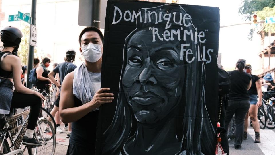 A protester in Richmond, Virginia holds a banner showing the face of Dominique “Rem’mie” Fells at the Black Women Matter “Say Her Name” march in July. (Photo by Eze Amos/Getty Images)