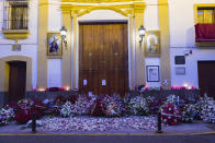 Flowers at the entrance of "Esperanza de Triana" brotherhood, after an Easter Holy Week procession was cancelled due to the coronavirus outbreak in Seville, Spain, Thursday, April 9, 2020. The COVID-19 coronavirus causes mild or moderate symptoms for most people, but for some, especially older adults and people with existing health problems, it can cause more severe illness or death. (AP Photo/Laura Leon)