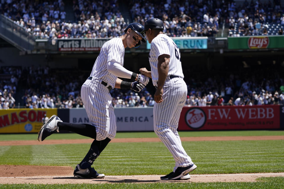 New York Yankees' Aaron Judge, left, celebrates with third base coach Luis Rojas after hitting a home run during the first inning of a baseball game against the Oakland Athletics at Yankee Stadium, Wednesday, June 29, 2022, in New York. (AP Photo/Seth Wenig)