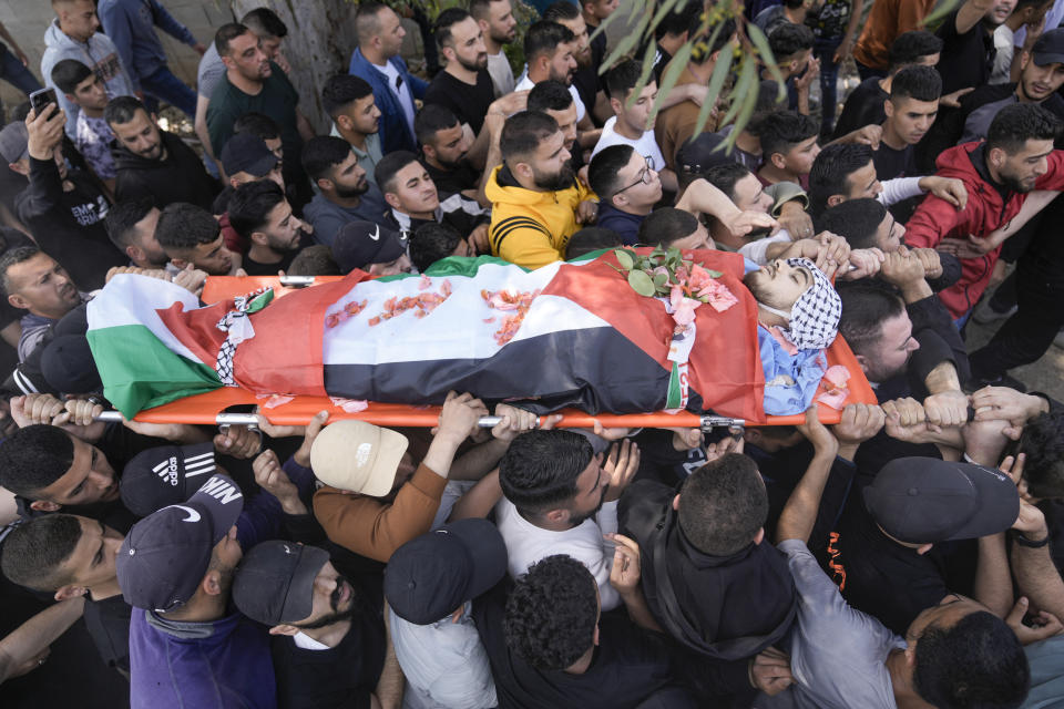 Palestinian men carry the body of Yazan Shtayyeh,17, killed in an Israeli military raid, during his funeral in West Bank village of Salem, Near the Palestinian town of Nablus, Monday, April 15, 2024. (AP Photo/Majdi Mohammed)