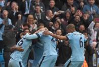 Manchester City's Fernandinho celebrates with teammates after scoring during the Premier League match against Aston Villa at Etihad stadium on April 25, 2015