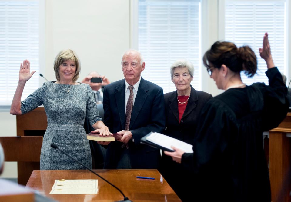 Judge Lisa Small (right) swears in newly elected Town Council member Bobbie Lindsay (left) to a two-year term in 2016 while her parents Alan and Barbara Lindsay stand with her.