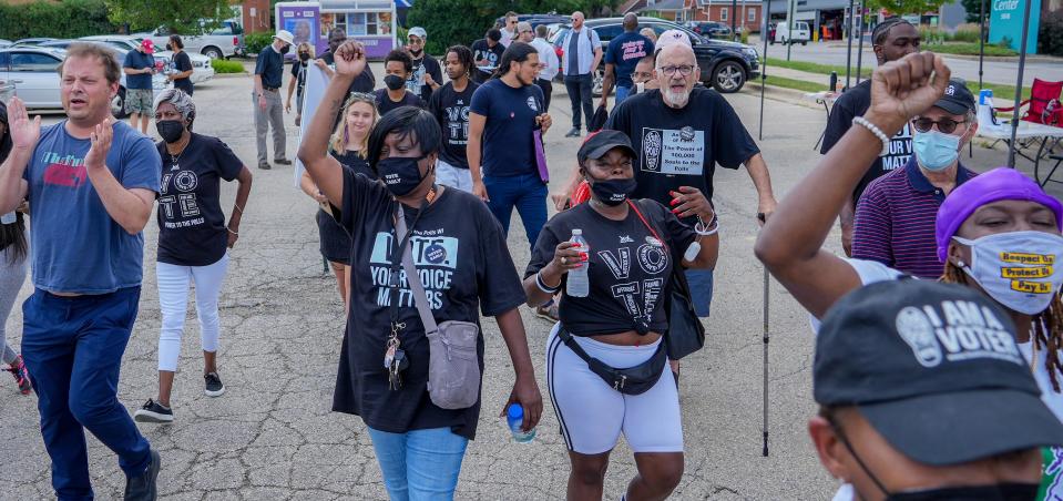 Voters march to the polls to vote following the press conference encouraging those to vote during the partisan primary election Tuesday, July 26, 2022, at Midtown Center in Milwaukee. Early voting  is now through August 6, 2022.