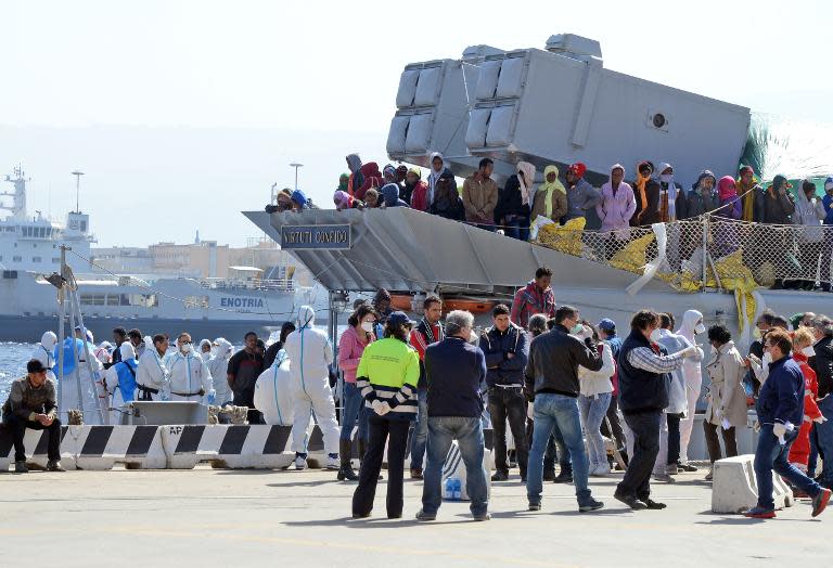 A boat transporting migrants arrives in the port of Messina after a rescue operation at see on April 18, 2015 in Sicily