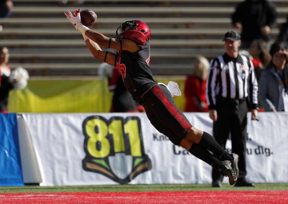 San Diego State wide receiver Jesse Matthews dives for a touchdown reception during the first half of the New Mexico Bowl NCAA college football game against Central Michigan on Saturday, Dec. 21, 2019 in Albuquerque, N.M. (AP Photo/Andres Leighton)