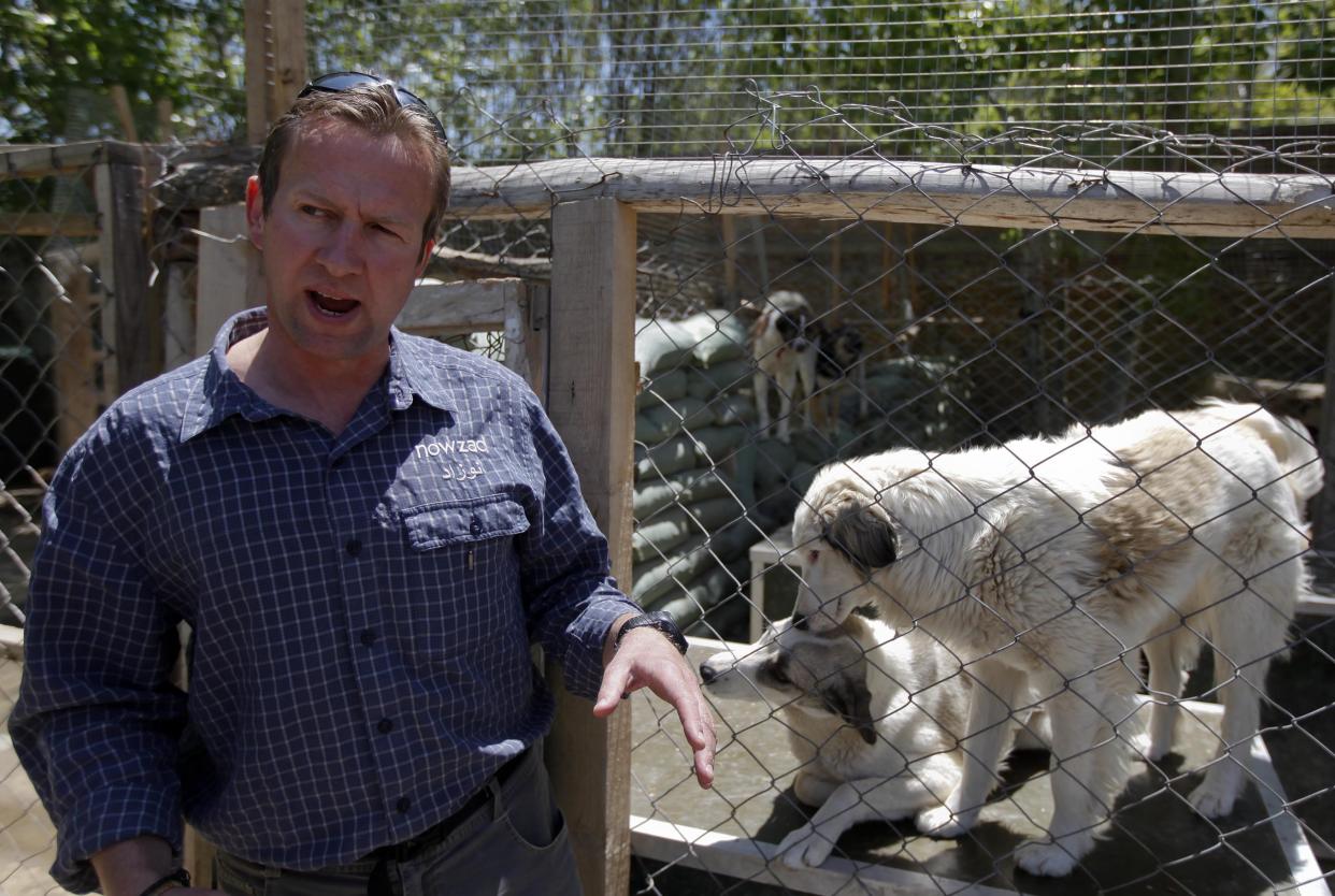 Pen Farthing, founder of British charity Nowzad, an animal shelter, stands in front of a cage on the outskirts of Kabul May 1, 2012. A former Royal Marine, Farthing adopted his dog Nowzad, named after a Helmand district, during his tour there in 2006. He then set up the charity, where dogs and some cats are neutered and vaccinated against rabies before their journeys abroad. Nowzad has given homes to over 330 dogs since it was founded, mostly to soldiers from the U.S. and Britain, but also from South Africa, Australia, Canada and the Netherlands. Picture taken May 1, 2012. REUTERS/Omar Sobhani (AFGHANISTAN - Tags: ANIMALS SOCIETY)