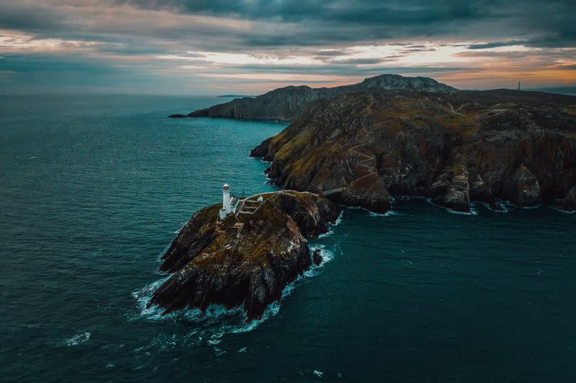 North Stack lighthouse. In the distance is Holyhead Mountain, the highest point on the path