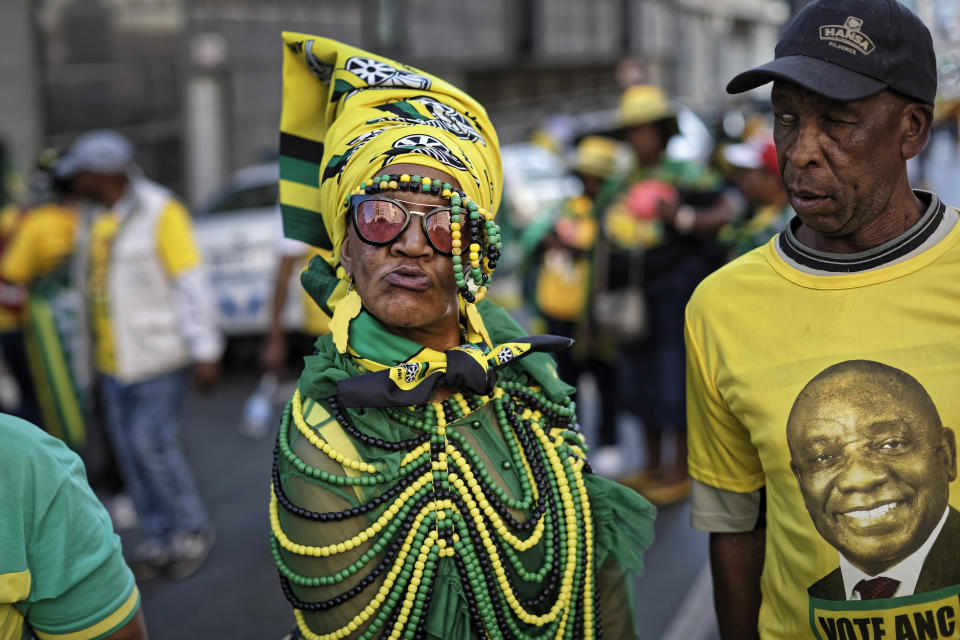 FILE - In this Sunday, May 12, 2019 file photo, a supporter of the African National Congress (ANC) party wears beads in the party colors, and another wears a t-shirt of President Cyril Ramaphosa, right, during an election victory rally in downtown Johannesburg, South Africa. These African stories captured the world's attention in 2019 - and look to influence events on the continent in 2020. (AP Photo/Ben Curtis, File)