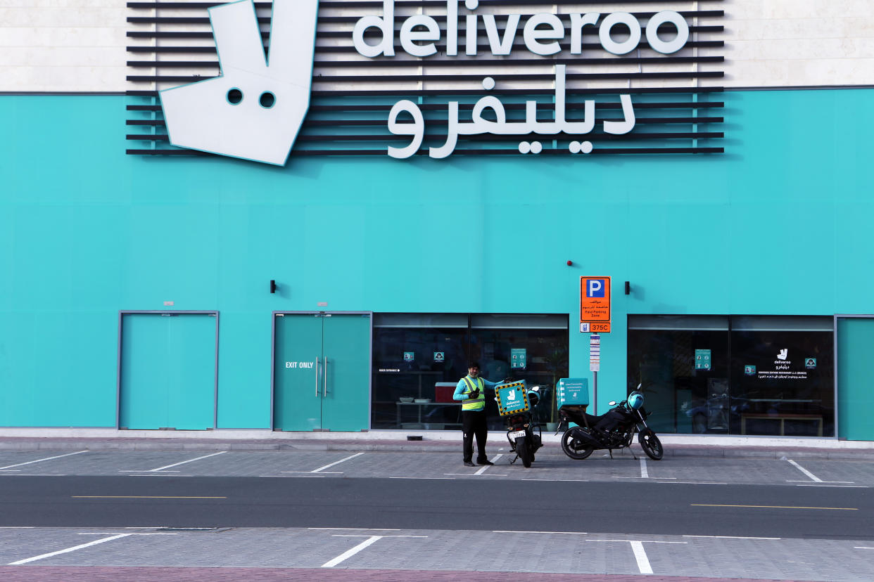 A food-delivery worker enters one of Deliveroo's delivery-only kitchens in Dubai, United Arab Emirates, May 2, 2022. Food-delivery drivers protesting wage cuts and grueling working conditions went on an extremely rare strike in Dubai on Saturday, April 30, 2022 — a mass walkout that paralyzed one of the country’s main delivery apps and revived concerns about labor conditions in the emirate. The strike ended early Monday, when London-based Deliveroo agreed to restore workers’ pay to $2.79 per delivery instead of the proposed rate of $2.38 amid surging fuel prices. (AP Photo/Isabel Debre)