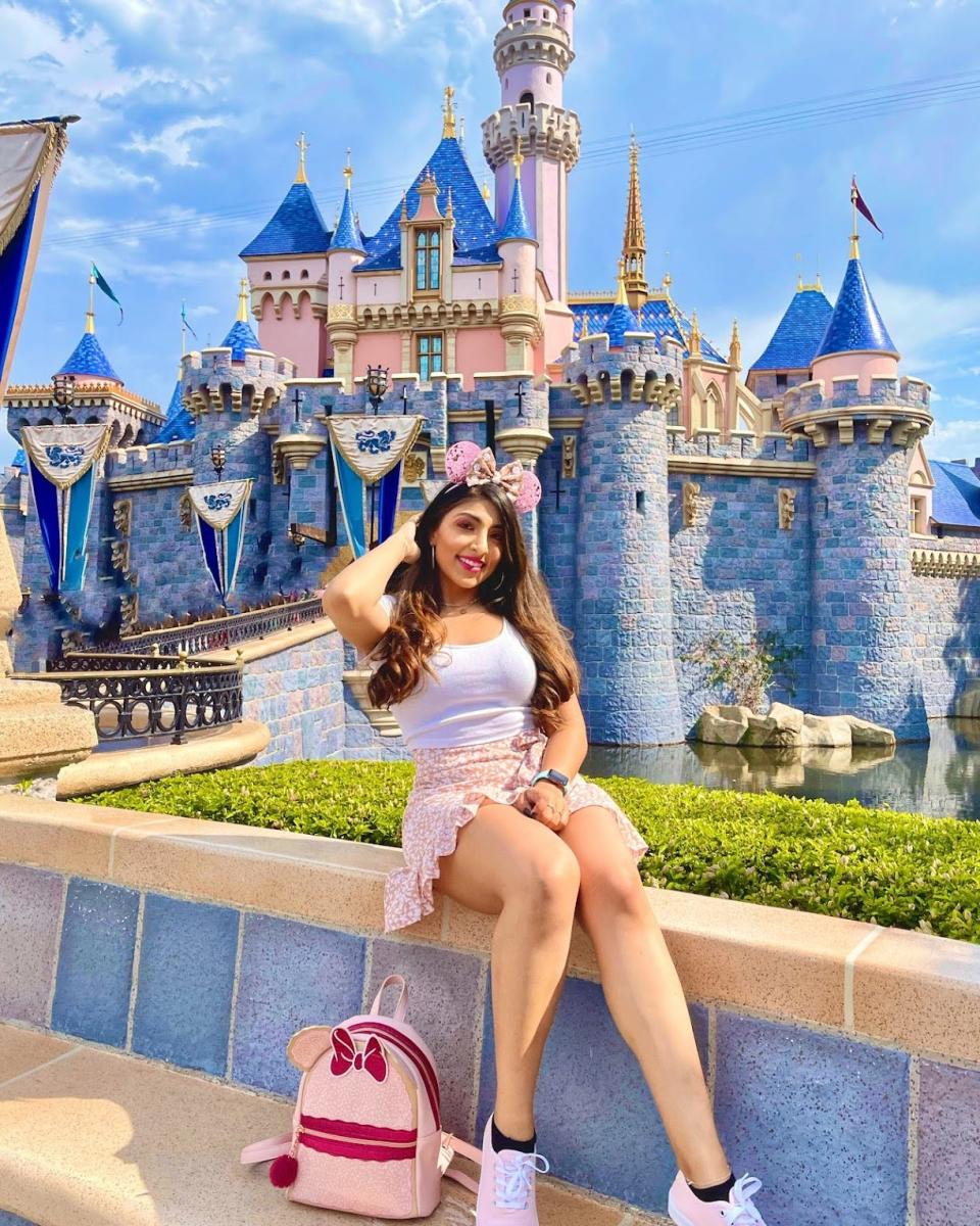 Priya Chadha sits near the castle at Disneyland in California.